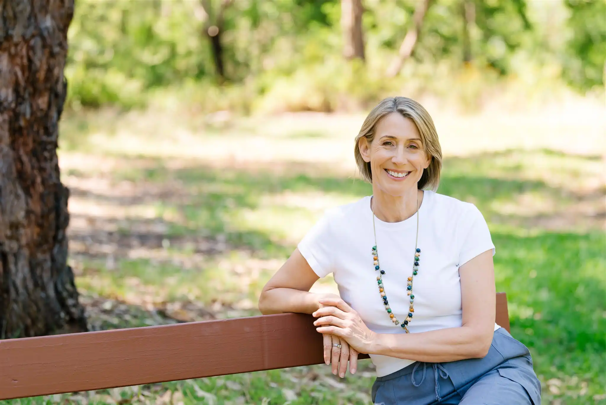 Woman Wearing White Top With Necklace